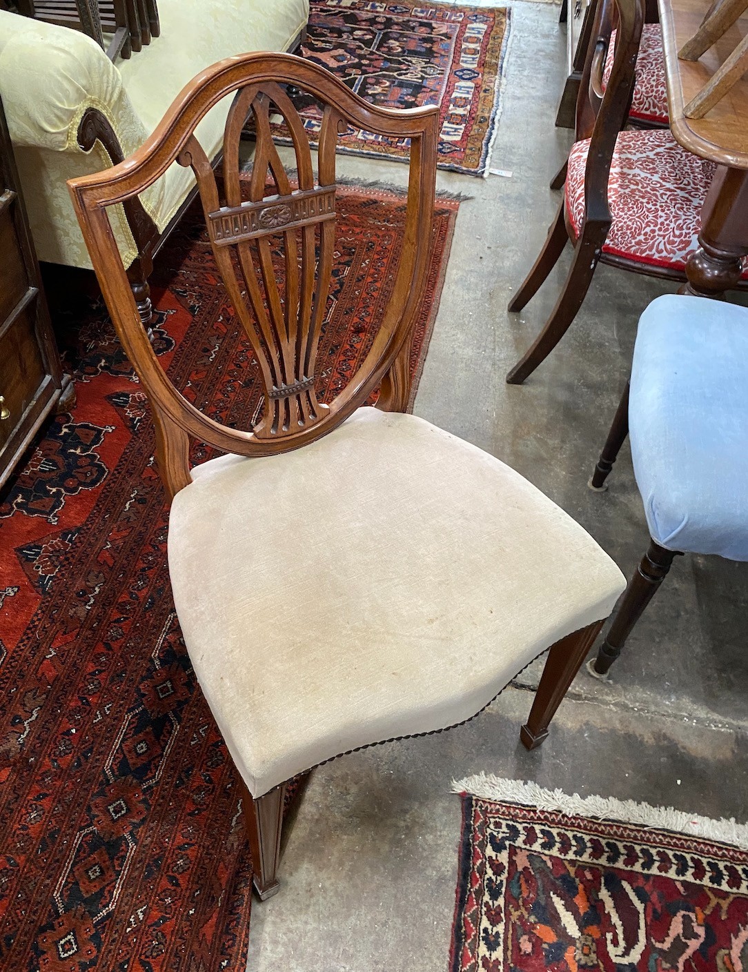 A William Tillman reproduction mahogany twin pedestal extending dining table, length 244cm extended, two spare leaves, depth 102cm, height 72cm and eight shield back dining chairs